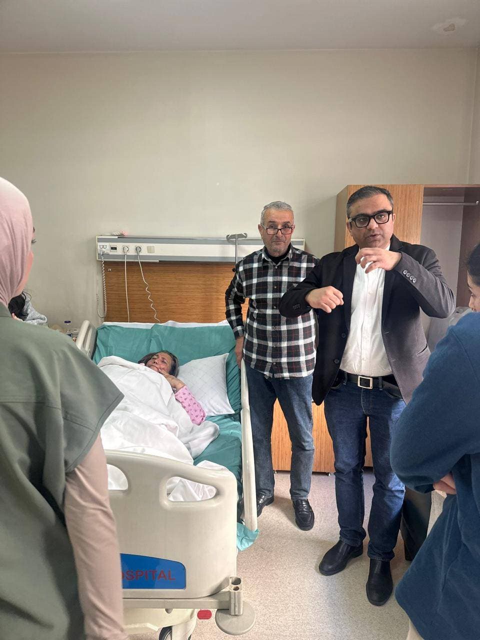 Dr. Ankur Singh explaining post-operative care to international patient and family
