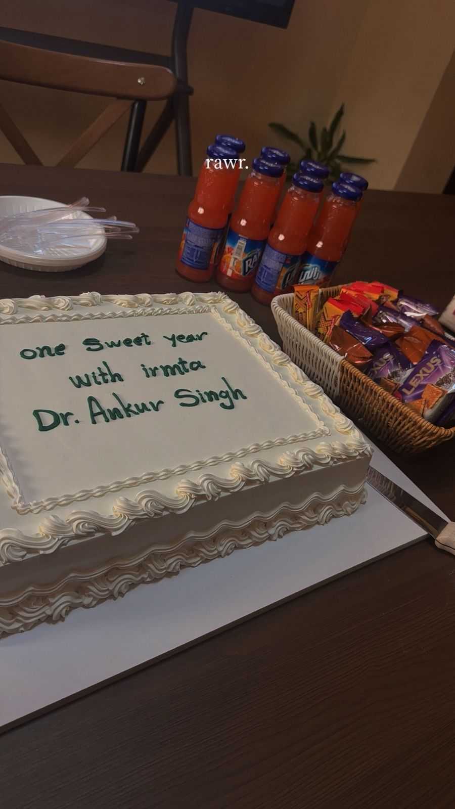 Celebration cake on a table with drinks and snacks.
