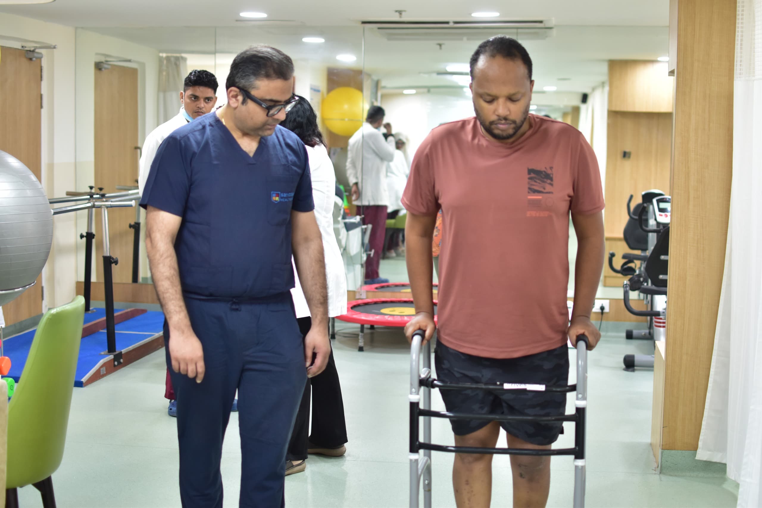 ACL surgery patient from Ethiopia practicing walking during recovery session