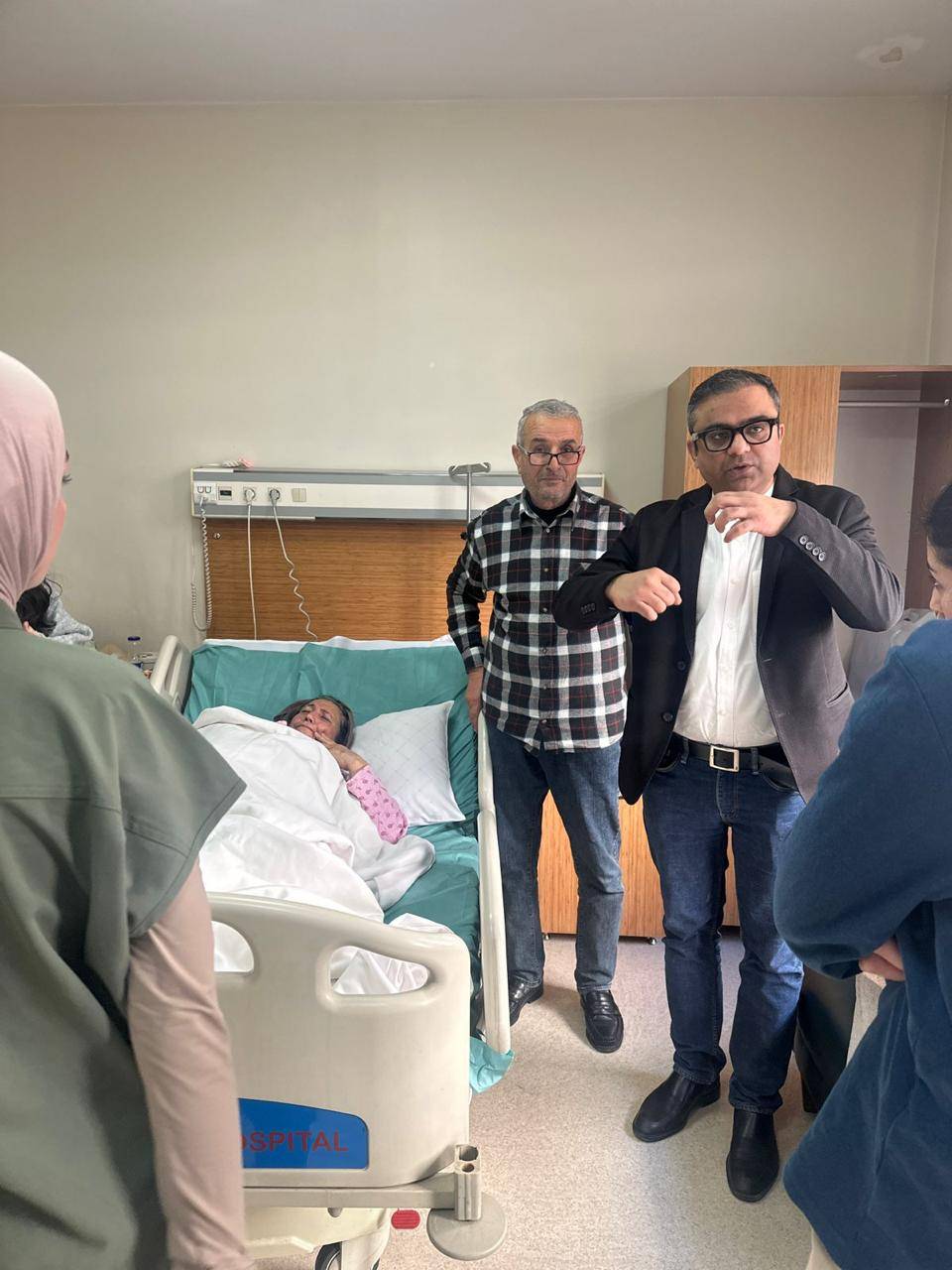 Dr. Ankur Singh explaining post-operative care to international patient and family